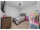 Cozy bedroom featuring carpeted floors, a ceiling fan, and playful decor at 2726 Harmonia Hammock Rd, Harmony, FL 34773