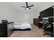 Functional bedroom with a work area, mini fridge, and neutral carpet at 2726 Harmonia Hammock Rd, Harmony, FL 34773