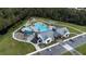 Aerial view of community pool and clubhouse with parking and lush landscape at 2726 Harmonia Hammock Rd, Harmony, FL 34773