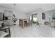 Bright dining area with tile floors, a dining table, and sliding glass doors at 2726 Harmonia Hammock Rd, Harmony, FL 34773