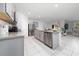 Open kitchen with stainless steel appliances, island, and granite countertops at 2726 Harmonia Hammock Rd, Harmony, FL 34773