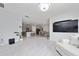 Open-concept living room seamlessly connects to the kitchen and dining area, perfect for modern living and entertaining at 2726 Harmonia Hammock Rd, Harmony, FL 34773