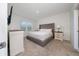 Cozy primary bedroom featuring a plush bed, neutral color palette, and ample natural light from a large window at 2726 Harmonia Hammock Rd, Harmony, FL 34773