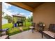 Outdoor patio area featuring seating, a grill setup, and a view of the expansive, well-maintained backyard at 2726 Harmonia Hammock Rd, Harmony, FL 34773
