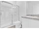 Bathroom with shower, toilet, sink, and granite counters, offering a clean and modern aesthetic at 2860 Poppy Avenue, Haines City, FL 33844