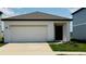 Charming single-Gathering home with a spacious two-car garage and well-manicured lawn on a sunny day at 2860 Poppy Avenue, Haines City, FL 33844