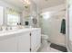 Bright bathroom featuring a double sink vanity with white cabinets and a glass enclosed shower at 2926 Dickens Cir, Kissimmee, FL 34747