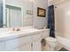 Standard bathroom featuring a white vanity, toilet, and tiled shower and tub at 2926 Dickens Cir, Kissimmee, FL 34747