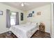 Cozy bedroom with hardwood floors, neutral paint, a ceiling fan, and ample natural light at 2926 Dickens Cir, Kissimmee, FL 34747