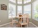 Cozy breakfast nook featuring a round table and chairs bathed in natural light from multiple windows at 2926 Dickens Cir, Kissimmee, FL 34747