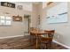 Bright dining area features a wooden table and chairs set on wood-look floors, complimented by a charming sailboat painting at 2926 Dickens Cir, Kissimmee, FL 34747