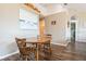 Bright dining area features a wooden table and chairs set on wood-look floors, a lovely painting on the wall at 2926 Dickens Cir, Kissimmee, FL 34747