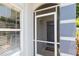 Welcoming entrance with screen door, sidelight and view to the gray painted front door at 2926 Dickens Cir, Kissimmee, FL 34747