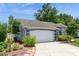Charming single-story home featuring a well-maintained lawn, mature trees, and a two-car garage at 2926 Dickens Cir, Kissimmee, FL 34747