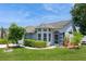 Attractive single-story home featuring a well-manicured lawn and a welcoming entrance with a screened door at 2926 Dickens Cir, Kissimmee, FL 34747