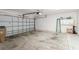 Spacious garage with a roll-up door and storage cabinets, providing ample space for parking and storage at 2926 Dickens Cir, Kissimmee, FL 34747