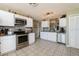 Well-equipped kitchen with stainless steel appliances, white cabinetry, and tile backsplash at 2926 Dickens Cir, Kissimmee, FL 34747