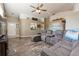 Open-concept living room featuring a large sectional sofa, high ceilings, and wood-look floors at 2926 Dickens Cir, Kissimmee, FL 34747