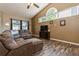 Inviting living room with a large sectional sofa, vaulted ceilings, and wood-look floors, perfect for relaxation at 2926 Dickens Cir, Kissimmee, FL 34747