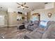 Relaxing living room featuring a comfortable sectional sofa, high ceilings, and wood-look floors at 2926 Dickens Cir, Kissimmee, FL 34747