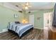 Comfortable main bedroom features vaulted ceilings, wood-look floors, and an ensuite bathroom at 2926 Dickens Cir, Kissimmee, FL 34747