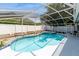 Stunning pool and spa, enclosed for year-round enjoyment and outdoor relaxation, with tidy garden beds around it at 2926 Dickens Cir, Kissimmee, FL 34747