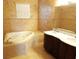 Bathroom featuring a soaking tub, double sink vanity, and tiled floors at 3074 Bay Laurel N Cir, Kissimmee, FL 34744