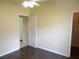 This is a bedroom with a ceiling fan, a doorway, and dark laminate floors at 3074 Bay Laurel N Cir, Kissimmee, FL 34744