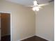 This is a bedroom with a ceiling fan, a doorway, and dark laminate floors at 3074 Bay Laurel N Cir, Kissimmee, FL 34744