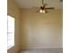 Comfortable bedroom with natural light, a ceiling fan, neutral wall color, and tile flooring at 3074 Bay Laurel N Cir, Kissimmee, FL 34744