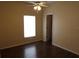 Bedroom with hardwood floors, ceiling fan, and a window for natural light at 3074 Bay Laurel N Cir, Kissimmee, FL 34744