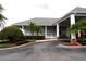 Attractive clubhouse entrance with landscaping, sidewalks, and covered entry for easy access at 3074 Bay Laurel N Cir, Kissimmee, FL 34744