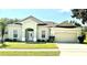Charming single-story home with a well-maintained lawn, a two-car garage, and a welcoming front entrance at 3074 Bay Laurel N Cir, Kissimmee, FL 34744