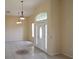 Inviting foyer featuring a decorative inlaid tile design, abundant natural light, and high ceilings at 3074 Bay Laurel N Cir, Kissimmee, FL 34744