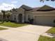 Charming single-story home featuring an attached two-car garage and well-maintained landscaping at 3074 Bay Laurel N Cir, Kissimmee, FL 34744