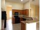 Bright kitchen with stainless sink and black appliances at 3074 Bay Laurel N Cir, Kissimmee, FL 34744