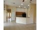 Spacious living room with tile floors open to the kitchen and hallways at 3074 Bay Laurel N Cir, Kissimmee, FL 34744