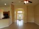 View of the entryway from the living room, showcasing an open layout with neutral walls and tile flooring at 3074 Bay Laurel N Cir, Kissimmee, FL 34744