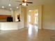 Open living room featuring tile flooring, a ceiling fan and a glimpse into the kitchen, great for entertaining at 3074 Bay Laurel N Cir, Kissimmee, FL 34744