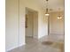 Expansive living area showcasing neutral walls, tile floors, with decorative chandelier lighting at 3074 Bay Laurel N Cir, Kissimmee, FL 34744