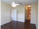 Well-lit main bedroom featuring a ceiling fan and wood flooring at 3074 Bay Laurel N Cir, Kissimmee, FL 34744