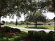 Picturesque view of a quiet neighborhood with well-maintained homes and a tranquil pond at 3074 Bay Laurel N Cir, Kissimmee, FL 34744