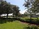 Scenic neighborhood view featuring mature trees, manicured lawns, and a paved roadway at 3074 Bay Laurel N Cir, Kissimmee, FL 34744