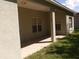 Covered patio featuring tiled flooring, support columns, and views of the backyard and grass at 3074 Bay Laurel N Cir, Kissimmee, FL 34744