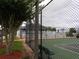Community tennis court behind fence with seating; nearby landscaping at 3074 Bay Laurel N Cir, Kissimmee, FL 34744