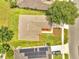 An aerial shot showcases the property's roof, yard, and landscaping, with neighboring homes and street in the background at 3274 Hunters Chase Loop, Kissimmee, FL 34743