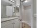 Bathroom vanity featuring granite countertops and walk-in shower with bright lighting at 3274 Hunters Chase Loop, Kissimmee, FL 34743