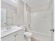 Well-lit bathroom with a shower-tub combo, vanity, and tile flooring at 3274 Hunters Chase Loop, Kissimmee, FL 34743