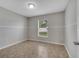 Bedroom with tile flooring, baseboards, and a bright window at 3274 Hunters Chase Loop, Kissimmee, FL 34743