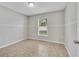 Bedroom with neutral walls, tile flooring, and a large window with blinds at 3274 Hunters Chase Loop, Kissimmee, FL 34743